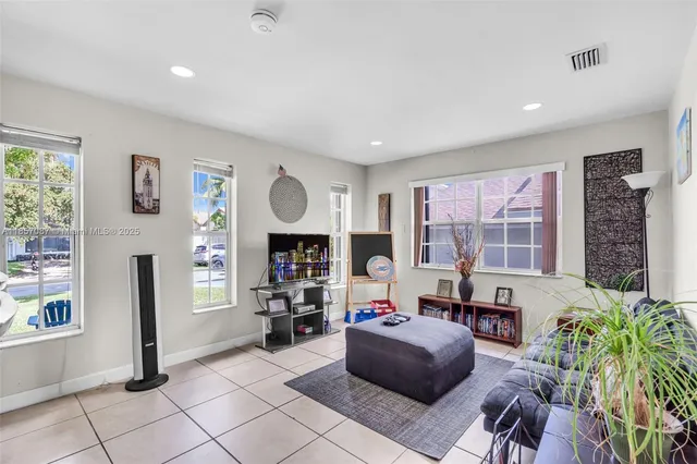 a living room with furniture and a bookshelf