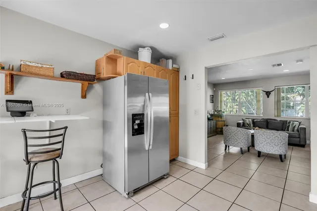 a kitchen with stainless steel appliances kitchen island granite countertop a refrigerator and a stove