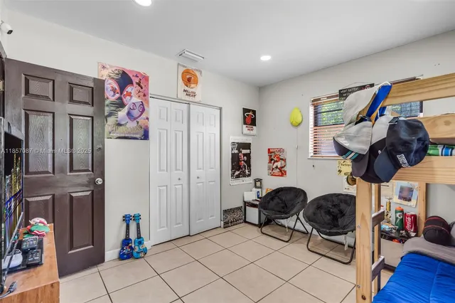 a bedroom with furniture and a fan