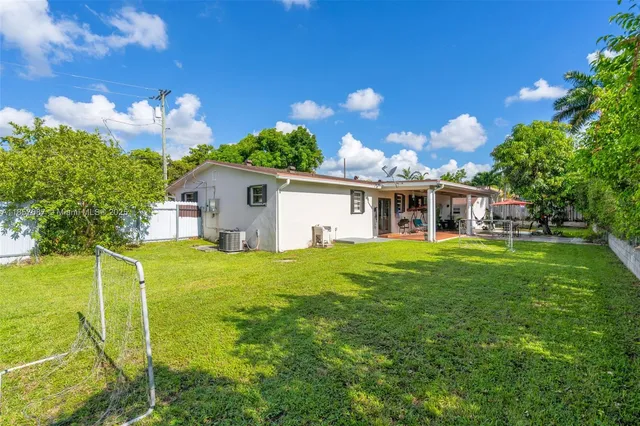 a front view of house with a garden