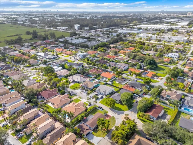 an aerial view of residential houses with outdoor space