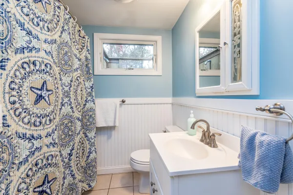a bathroom with a sink toilet and mirror