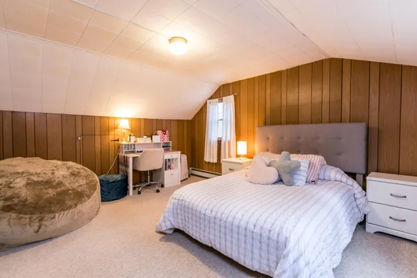 a bedroom with a bed and dresser