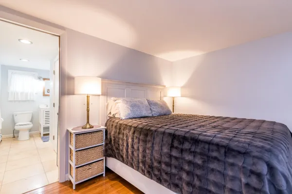 a bedroom with a bed and a lamp