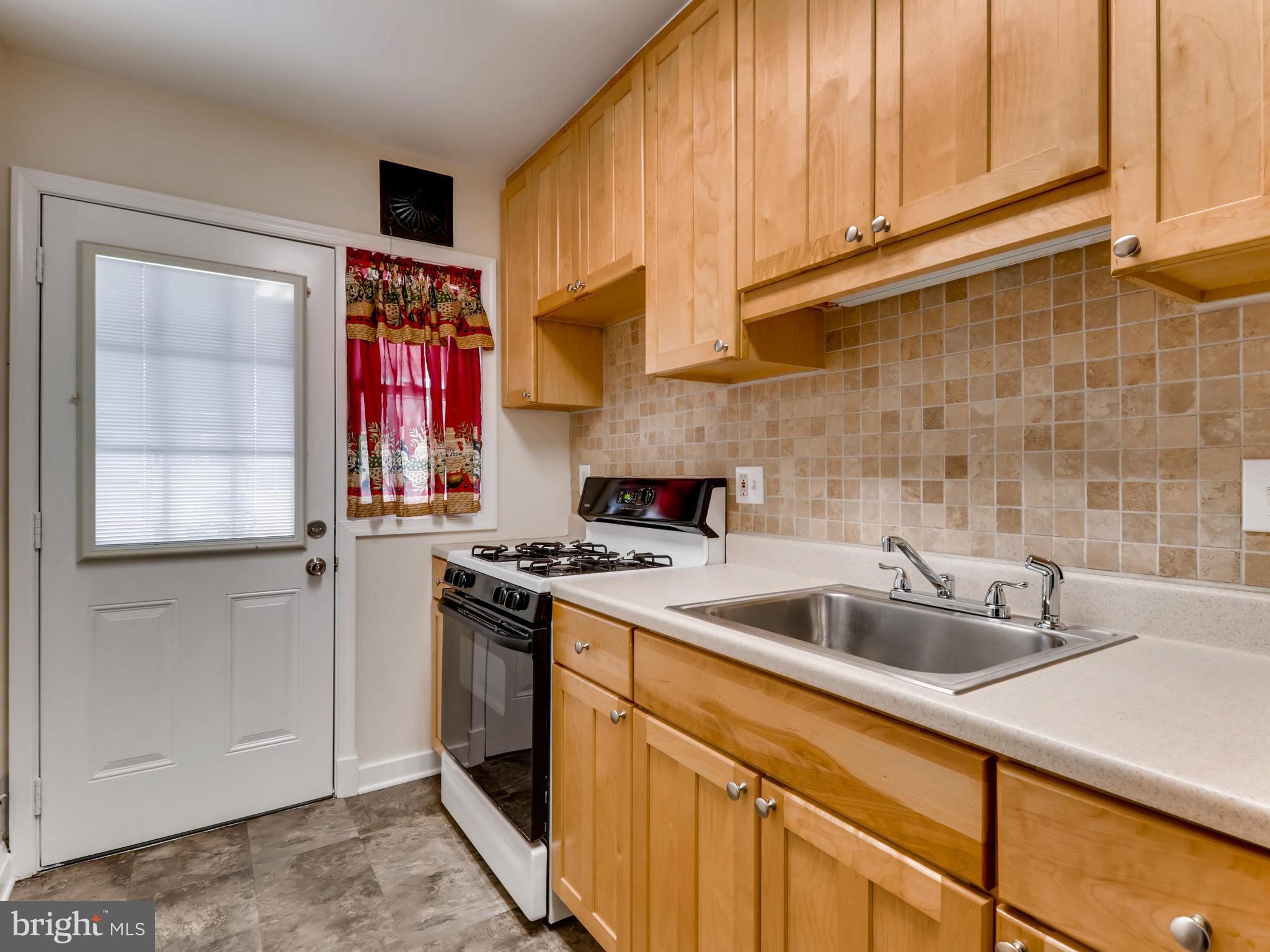 7915 Kavanagh Road Baltimore, MD 21222 - Photo 4 of 12 a kitchen with stainless steel appliances granite countertop a sink and a refrigerator