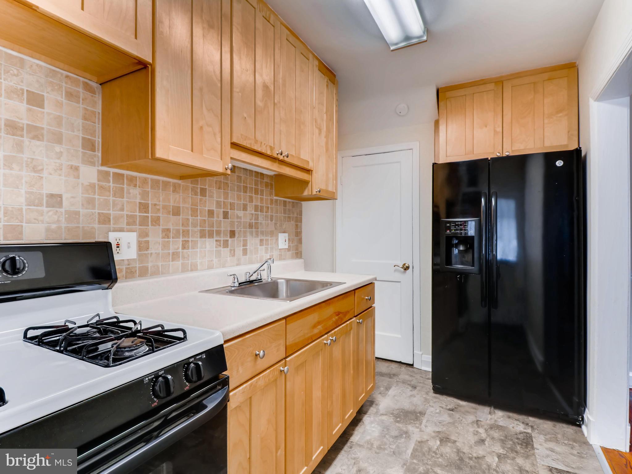 7915 Kavanagh Road Baltimore, MD 21222 - Photo 5 of 12 a kitchen with a stove and a refrigerator