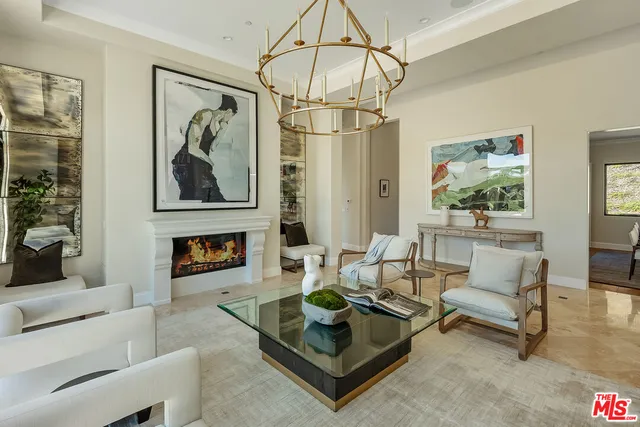 a kitchen with stainless steel appliances a kitchen island wooden floors and a view of living room