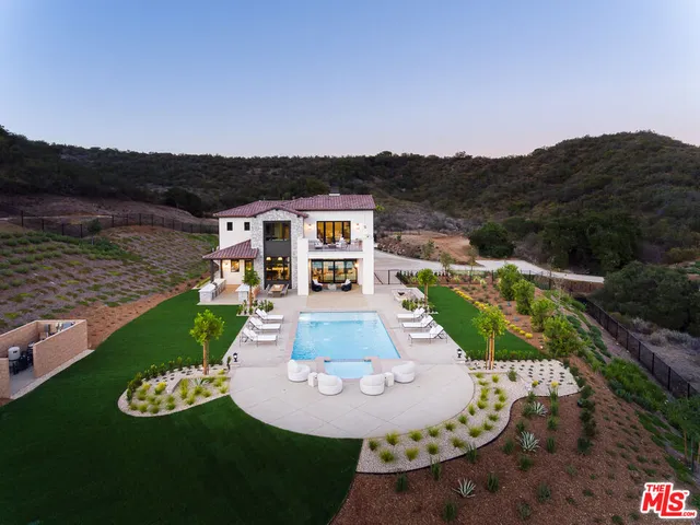 a view of a house with backyard porch and sitting area