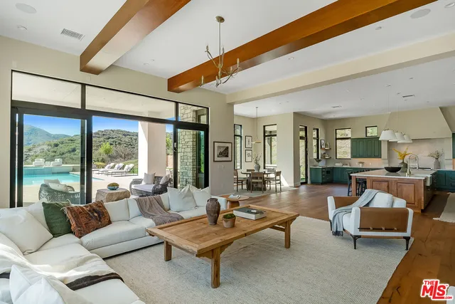 a bathroom with a granite countertop sink a mirror a vanity and a shower