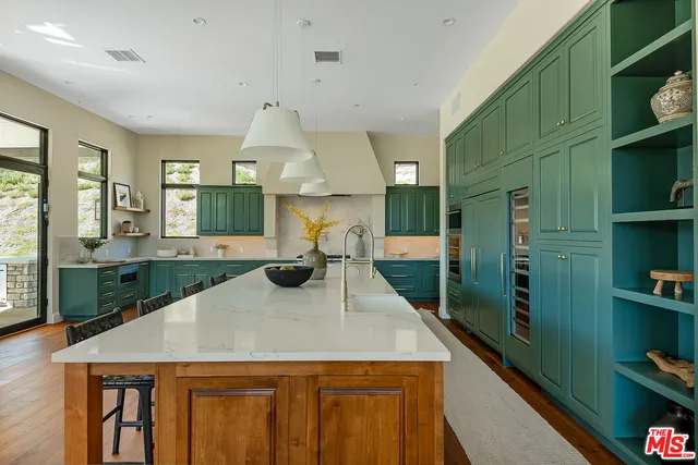 a bathroom with a granite countertop toilet sink and mirror