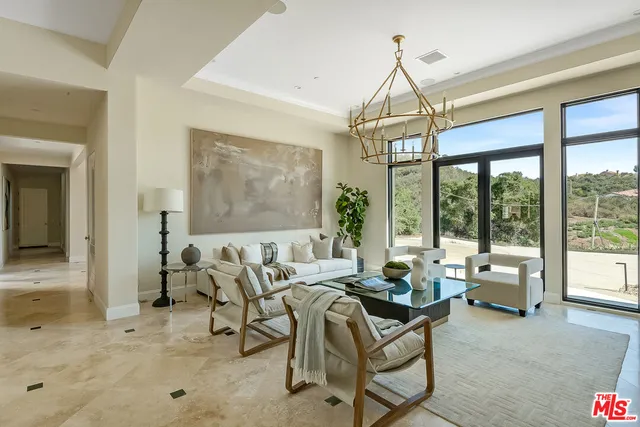 a living room with furniture and large windows