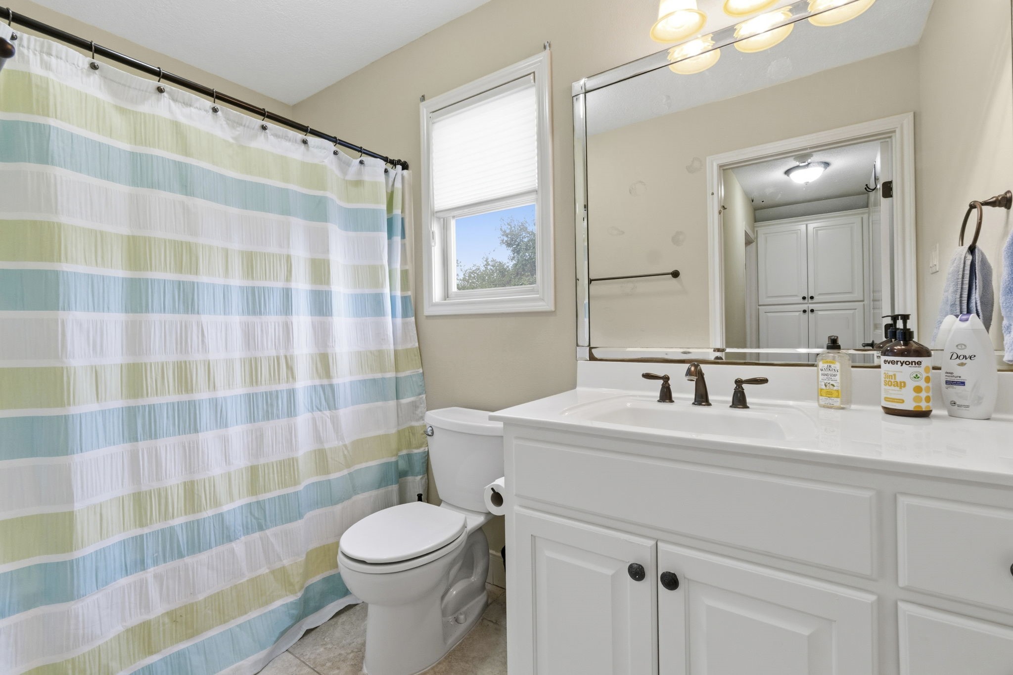 259 Memphis Bell Lane Trinity, TX 75862 - Photo 28 of 50 a bathroom with a sink toilet mirror and shower