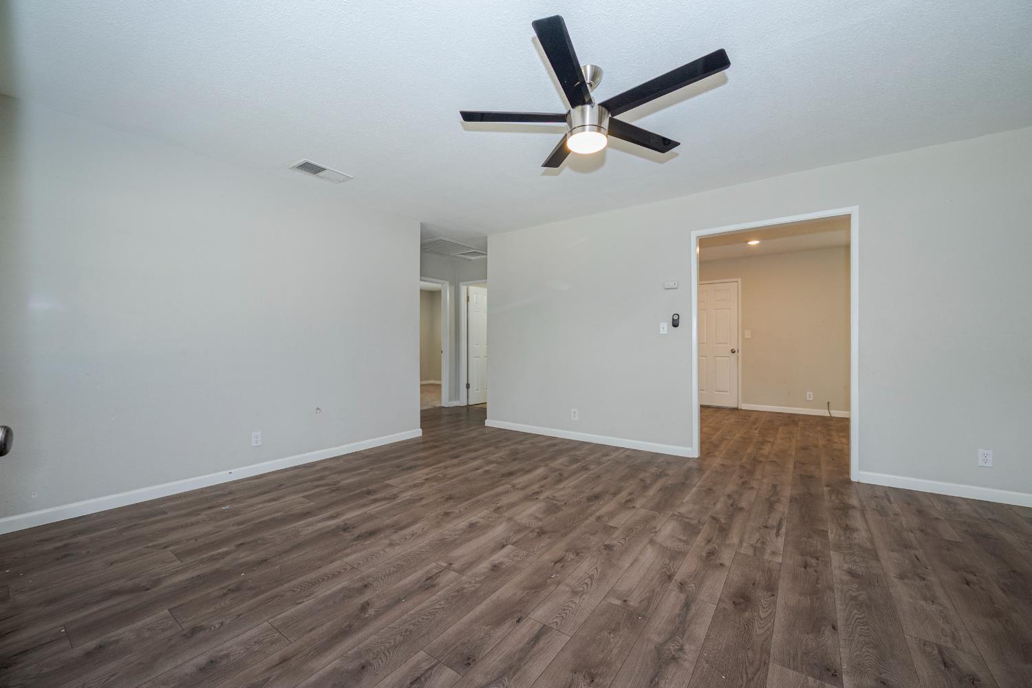 3085 North Buhach Road Atwater, CA 95301 - Photo 16 of 40 an empty room with wooden floor and windows