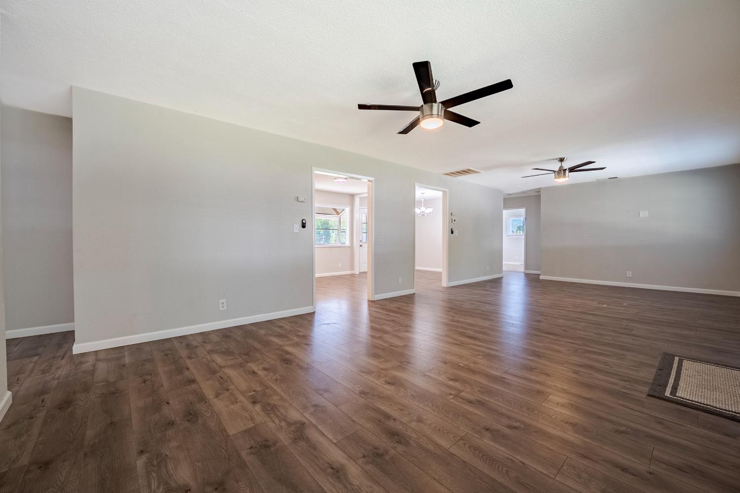 3085 North Buhach Road Atwater, CA 95301 - Photo 18 of 40 a view of a livingroom with wooden floor and ceiling fan