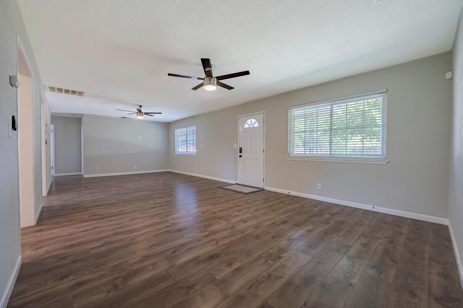 3085 North Buhach Road Atwater, CA 95301 - Photo 19 of 40 a view of empty room with wooden floor and ceiling fan