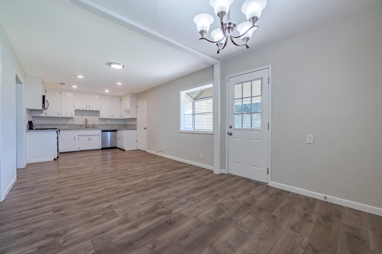 3085 North Buhach Road Atwater, CA 95301 - Photo 32 of 40 a view of a kitchen with a stove cabinets and wooden floor