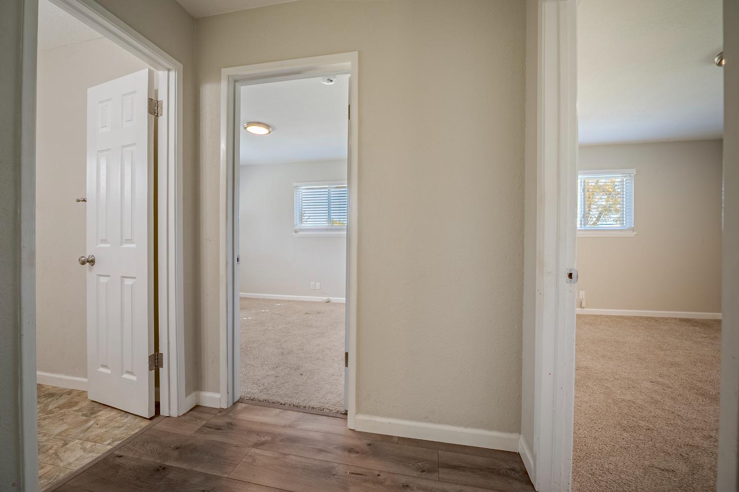 3085 North Buhach Road Atwater, CA 95301 - Photo 35 of 40 an empty room with wooden floor front door and windows