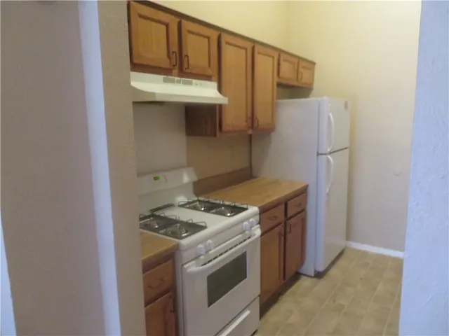 a kitchen with a stove and a refrigerator