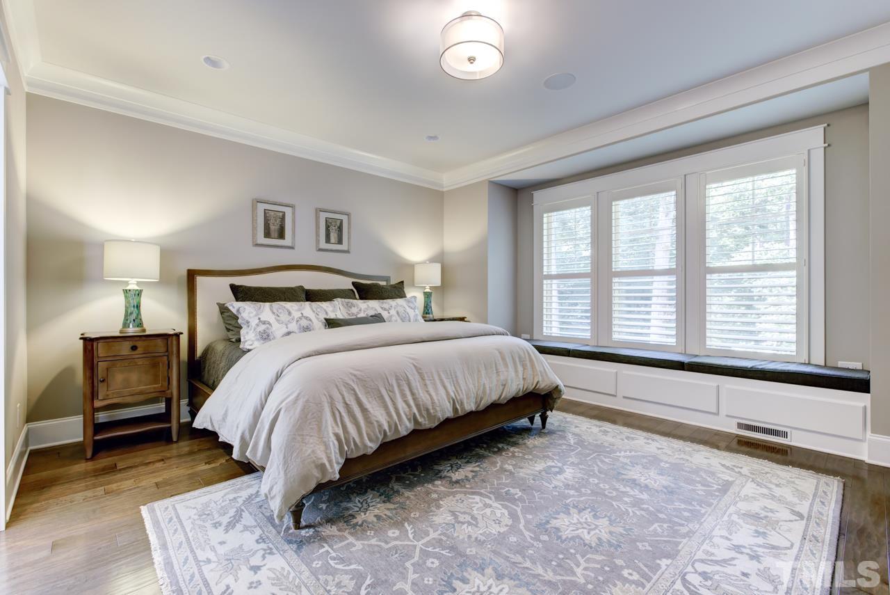 1003 Collins Drive Raleigh, NC 27609 - Photo 12 of 25 Have sweet dreams in the first floor master suite that includes a luxury bath with a large double vanity, Aquatic soaker tub, huge tiled shower, and a walk-in closet with custom organizers.