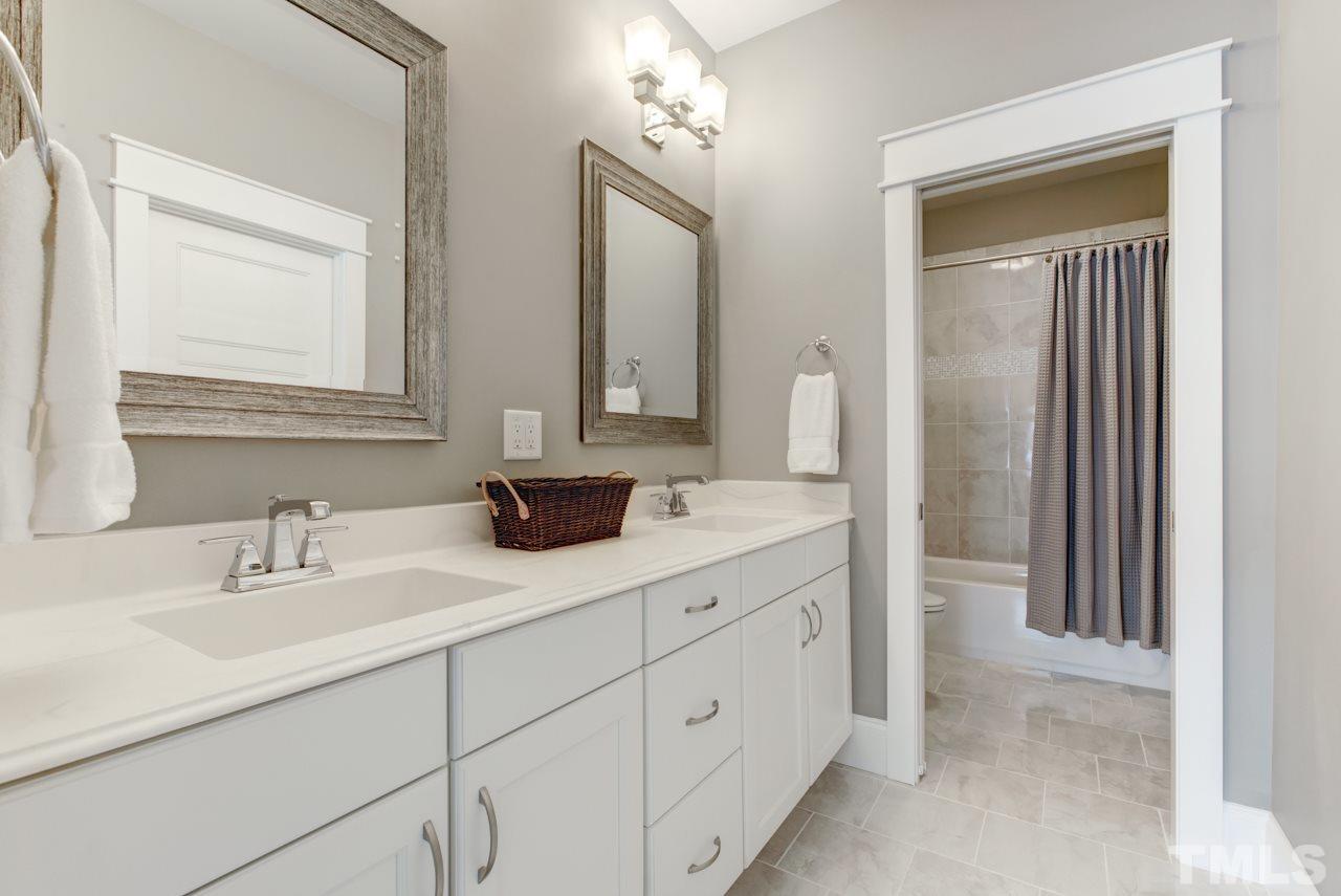 1003 Collins Drive Raleigh, NC 27609 - Photo 19 of 25 There are three additional bedrooms all with walk-in closets, and two with attached full baths.