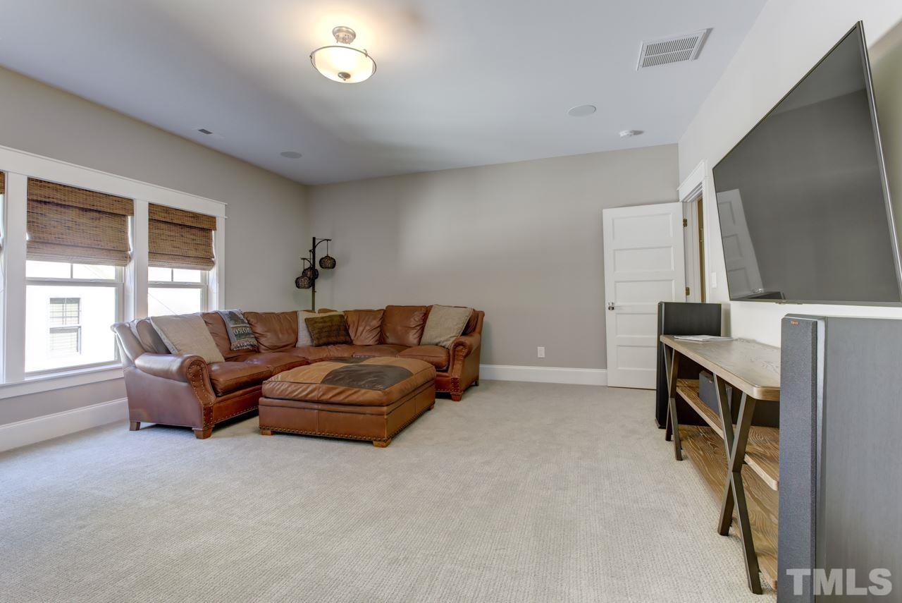 1003 Collins Drive Raleigh, NC 27609 - Photo 20 of 25 Finishing off this level is a bonus room perfect to use as a playroom or media room.