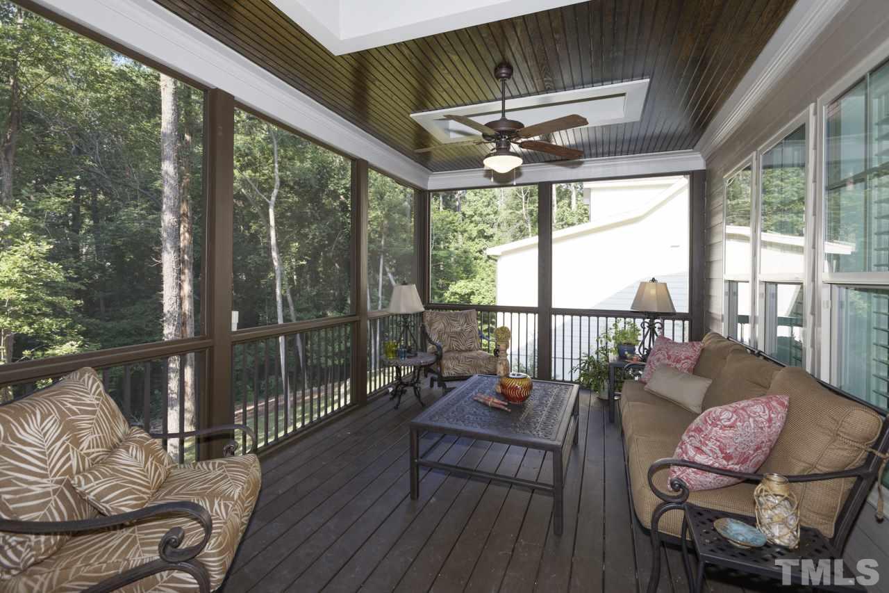 1003 Collins Drive Raleigh, NC 27609 - Photo 21 of 25 Relax after a long day in the screened porch that features a bead board ceiling, skylights, and a ceiling fan with light.