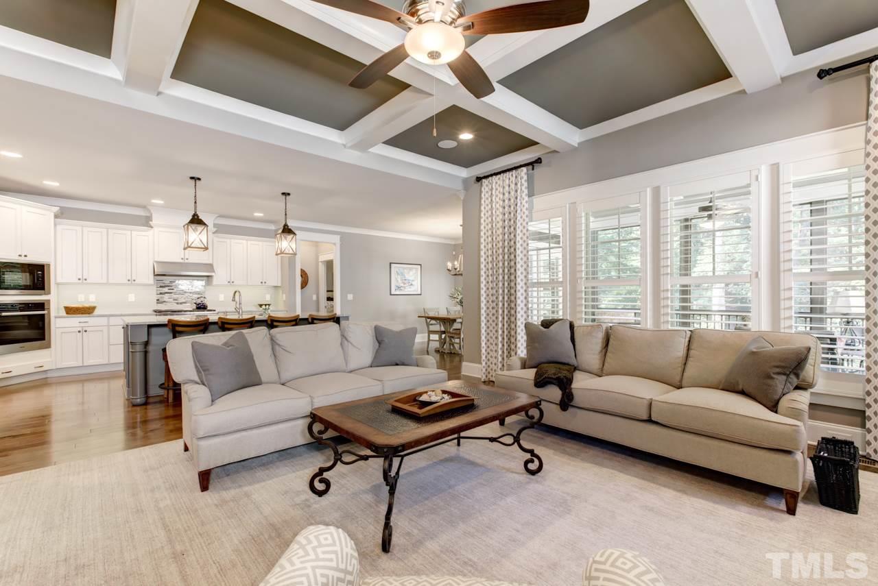 1003 Collins Drive Raleigh, NC 27609 - Photo 9 of 25 The family room boasts a coffered ceiling and features a stacked stone fireplace with side bookcases. There is also wall of windows covered with beautiful Plantation shutters.