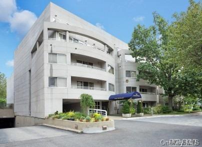 100 Cutter Mill Road, Unit 4R Great Neck, NY 11021 - Photo 1 of 1 a front view of a building with garden