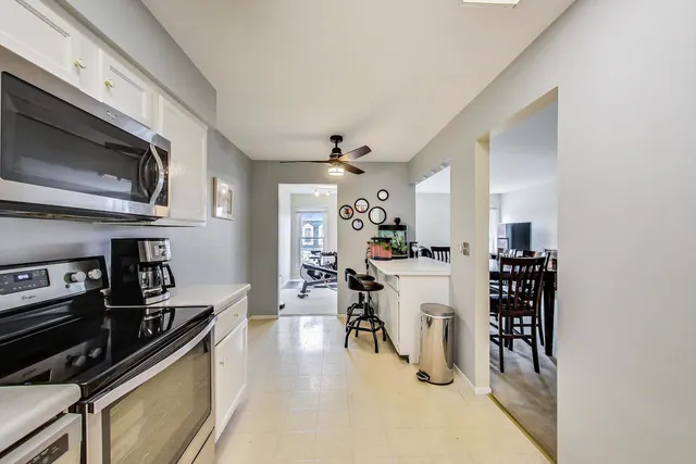 a kitchen with a sink a microwave and cabinets