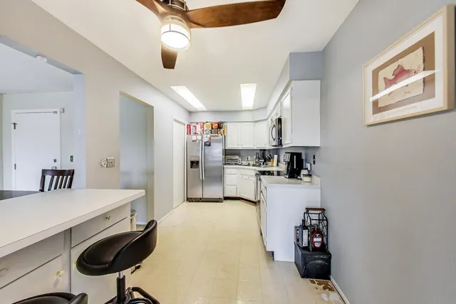 a kitchen with kitchen island a stove and a refrigerator