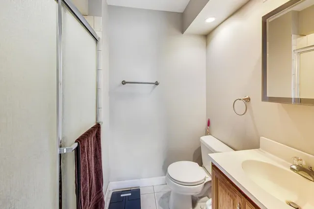 a white toilet sitting next to a bathroom sink and vanity