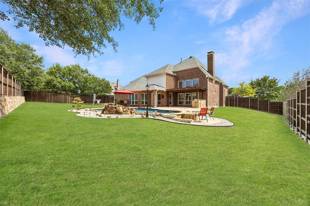 1011 Three Rivers Drive Prosper, TX 75078 - Photo 7 of 27 a front view of a house with swimming pool and garden