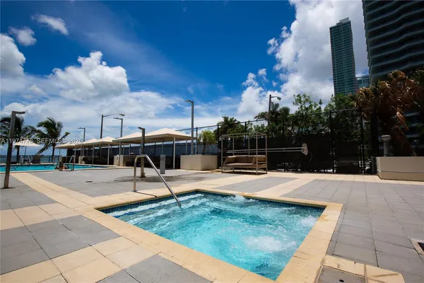 a view of a swimming pool with an outdoor space and seating area