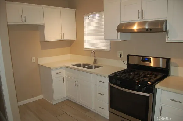 a kitchen with sink and cabinets