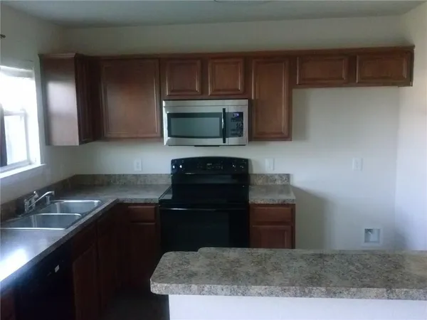 a kitchen with a sink and a stove top oven