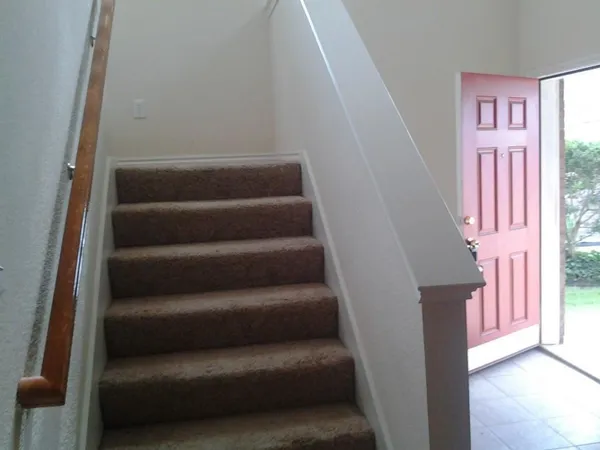 a view of staircase with white walls