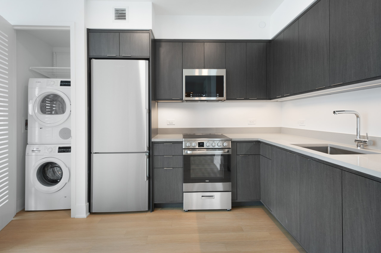 a kitchen with stainless steel appliances a refrigerator a sink and a stove
