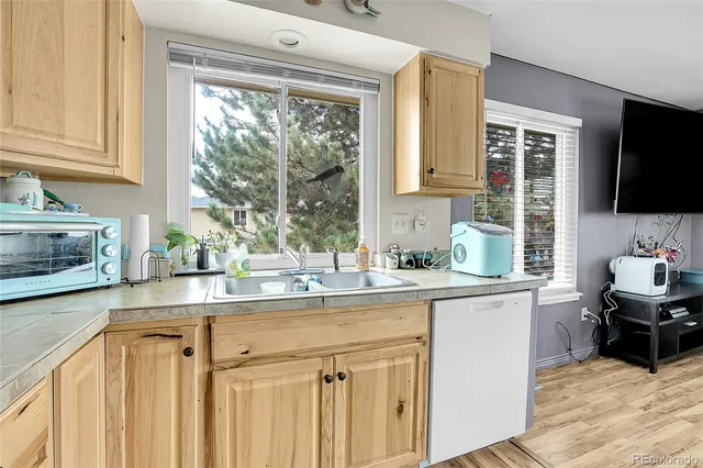 a kitchen with stainless steel appliances a sink a stove and a window