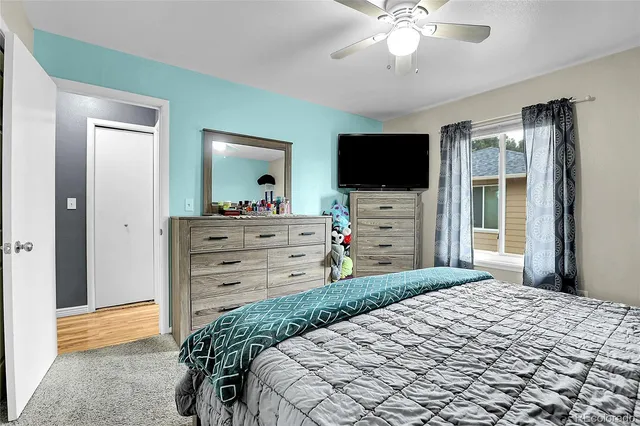 a bedroom with a bed and a flat screen tv