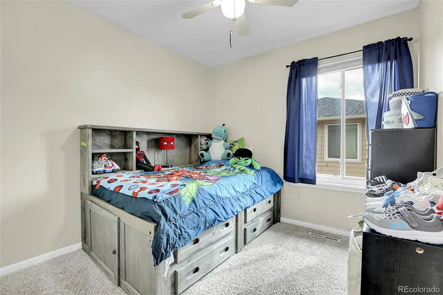 a bedroom with bed and window