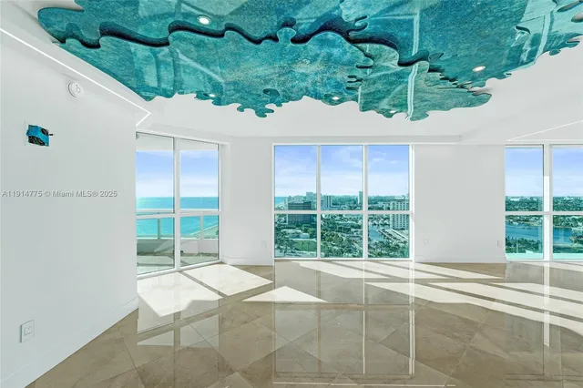 a view of a room with wooden floor and windows