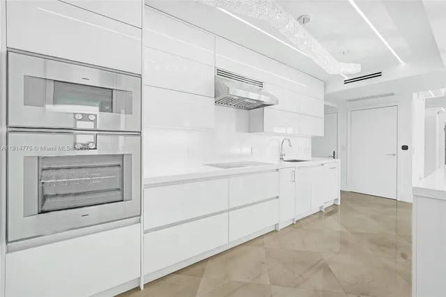 a bedroom with a bed and large windows