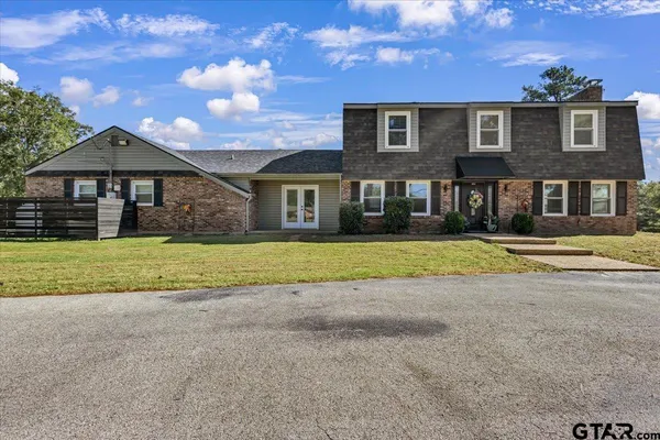 a view of house with yard and green space