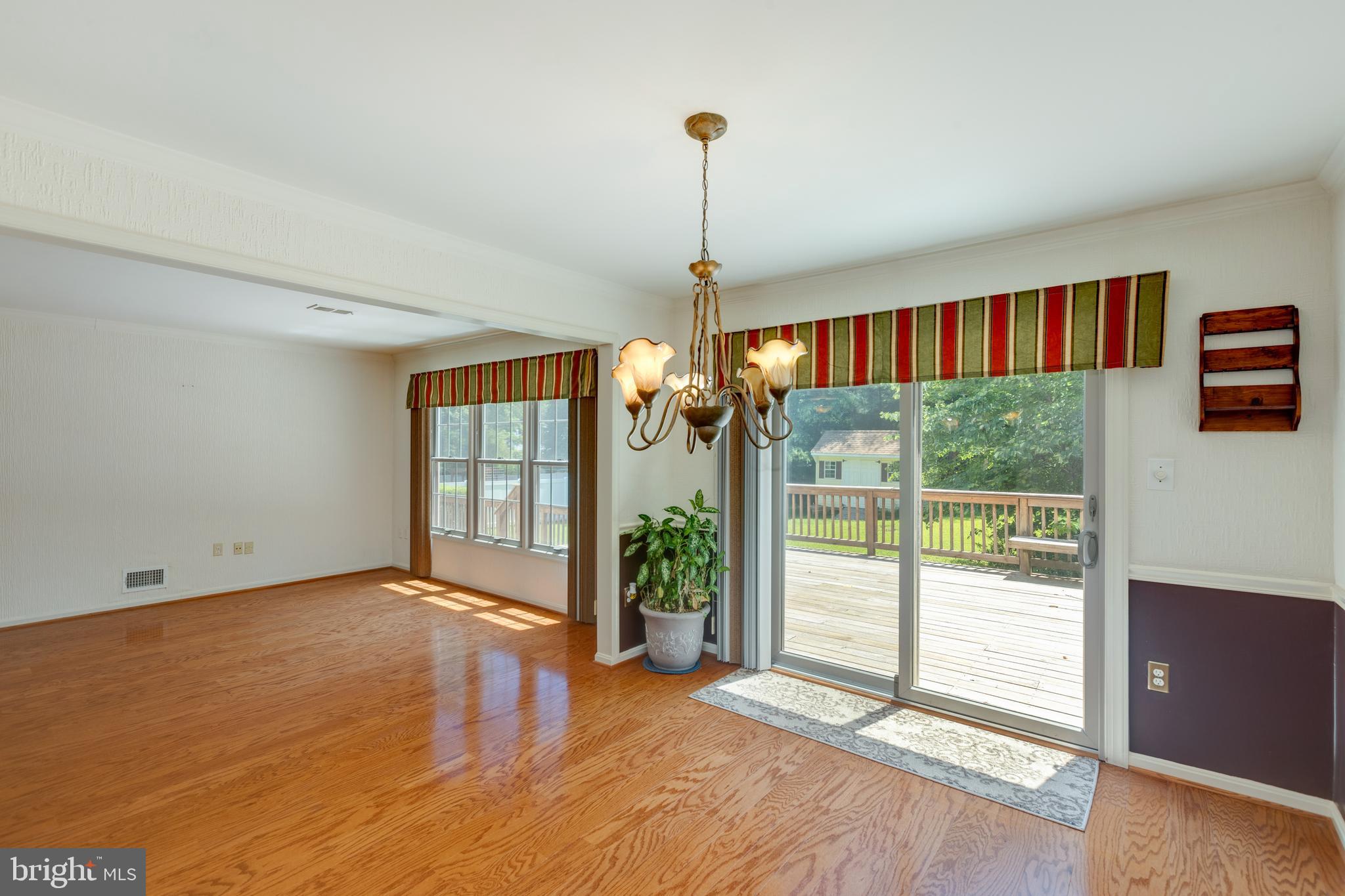 11821 Riders Lane Reston, VA 20191 - Photo 12 of 44 a view of an empty room with wooden floor and a window