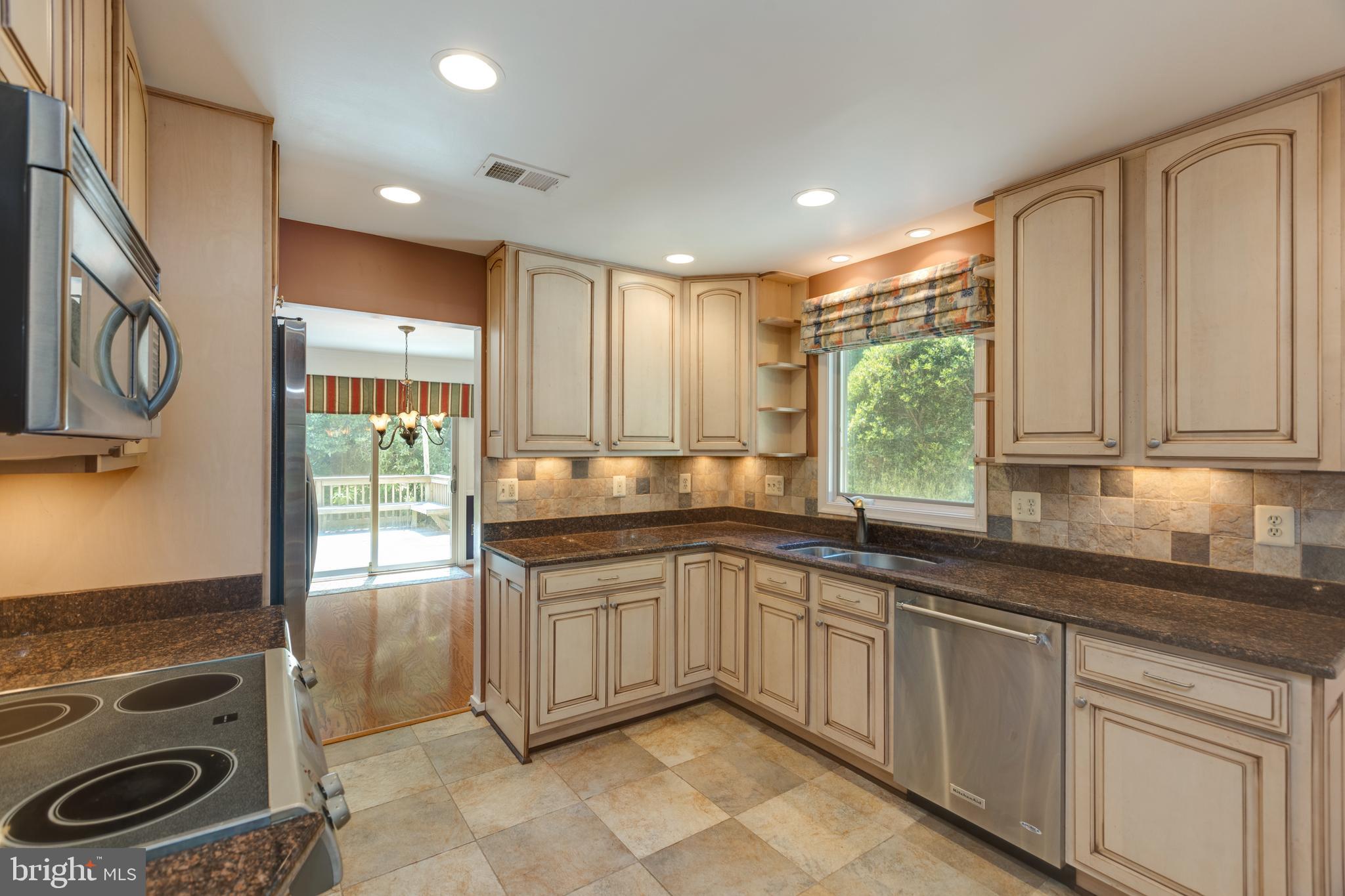 11821 Riders Lane Reston, VA 20191 - Photo 15 of 44 a kitchen with a sink stove and cabinets