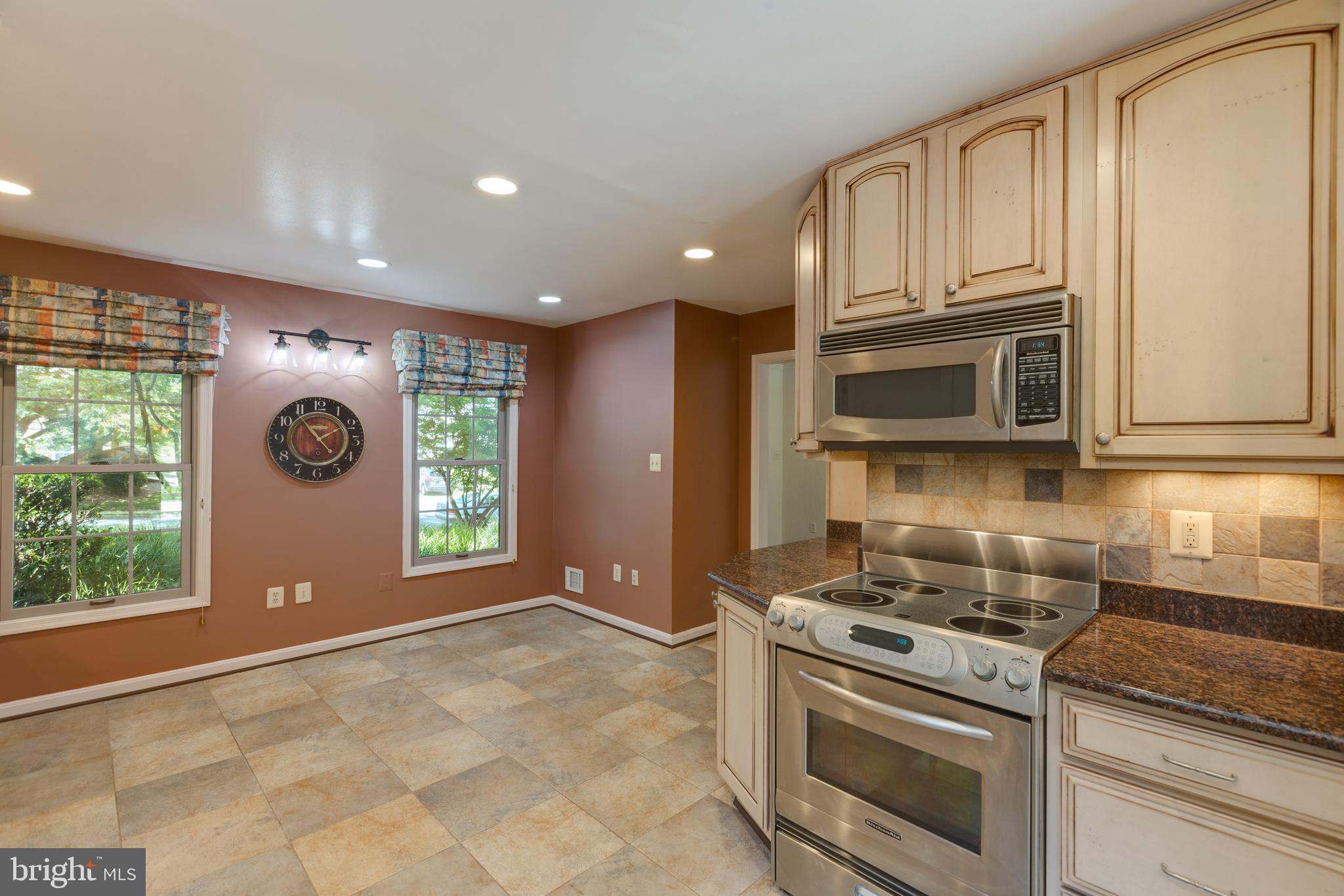 11821 Riders Lane Reston, VA 20191 - Photo 16 of 44 a kitchen with a stove and a microwave
