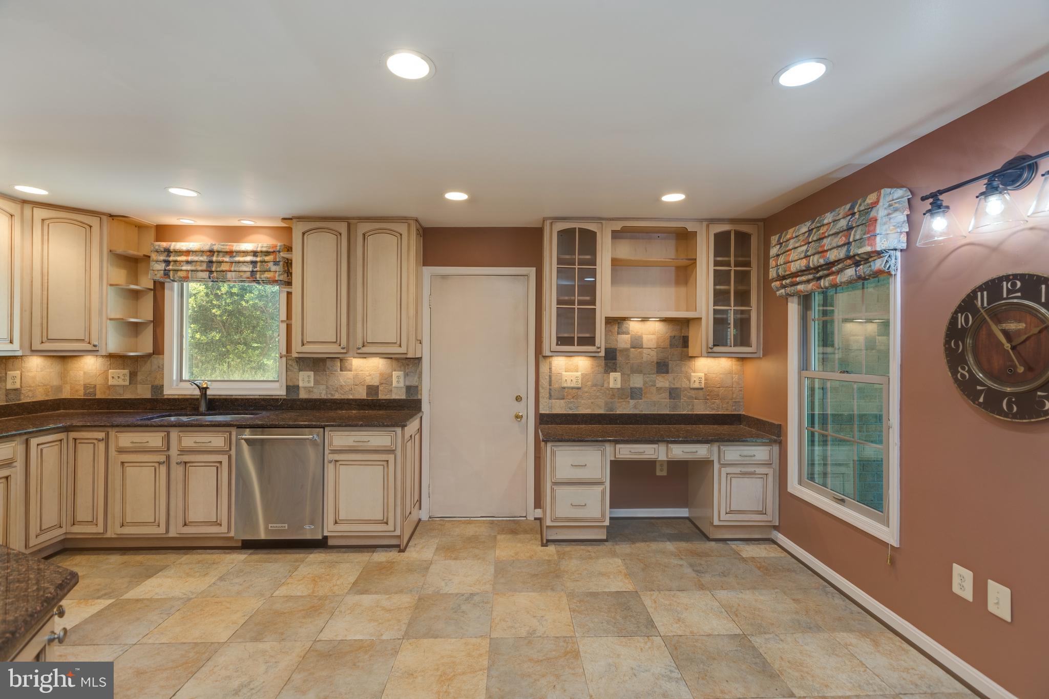 11821 Riders Lane Reston, VA 20191 - Photo 17 of 44 a large kitchen with stainless steel appliances granite countertop a stove and a refrigerator
