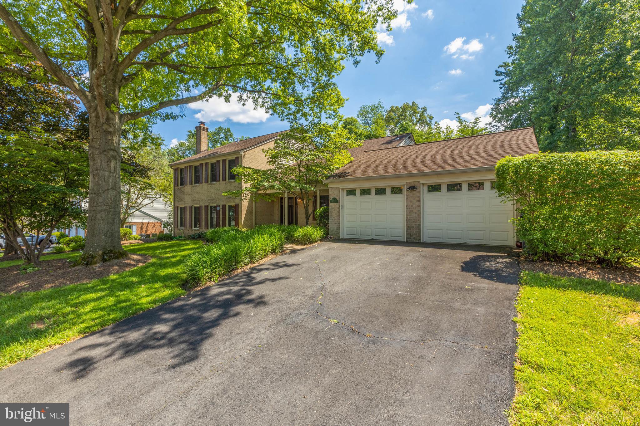 11821 Riders Lane Reston, VA 20191 - Photo 4 of 44 a view of a white house with a yard and potted plants
