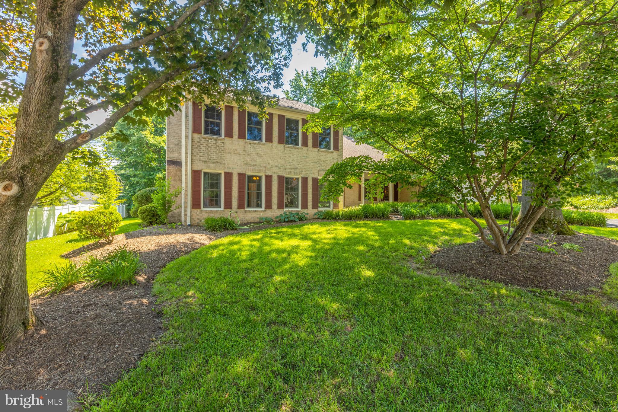 11821 Riders Lane Reston, VA 20191 - Photo 5 of 44 a front view of a house with yard and green space