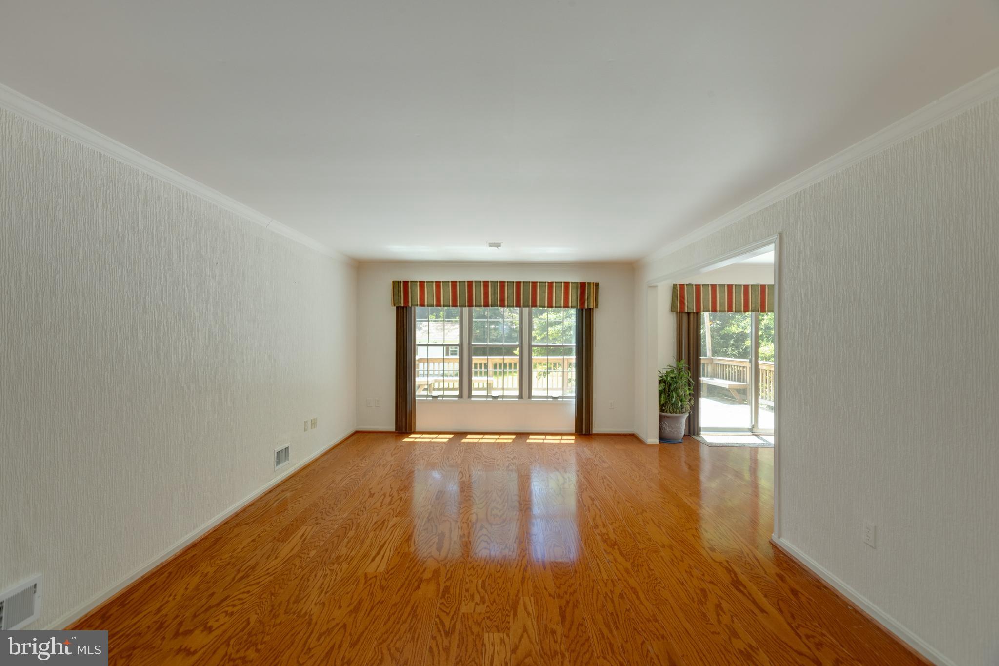 11821 Riders Lane Reston, VA 20191 - Photo 8 of 44 a view of an empty room with wooden floor and a window
